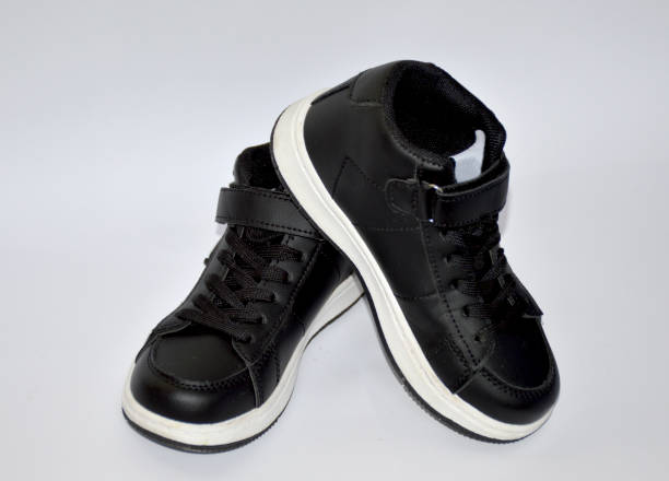istock children's sneakers in black with a white stripe on the sole on white background 2152959451