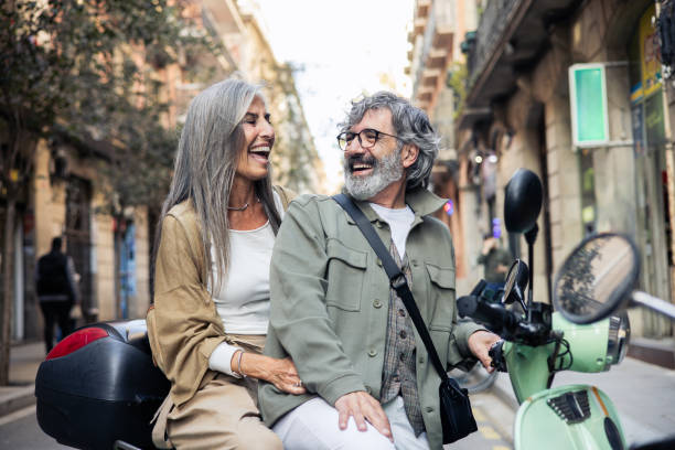 istock Mature couple having fun riding on a motor scooter 2152959771