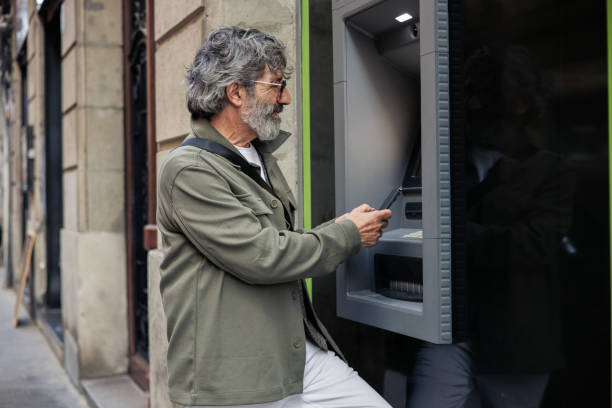 istock Mature man taking the money on the ATM 2152959772
