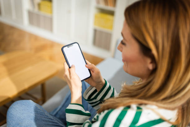 istock Young woman using a smart phone at home 2152959961