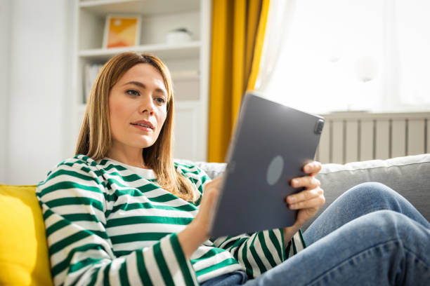 istock Young woman using digital tablet at home 2152960533