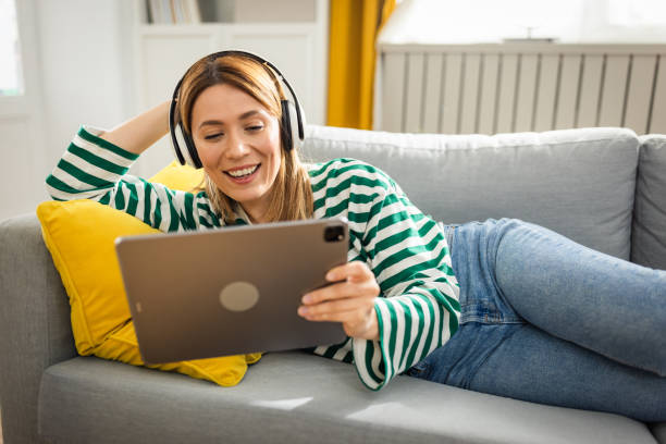 istock Young woman using digital tablet at home 2152960550
