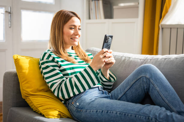 istock Young woman using a smart phone at home 2152960594