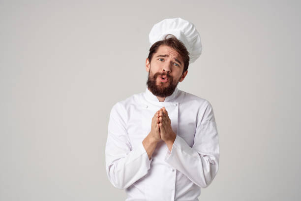 istock bearded man Chef uniform Cooking emotions gourmet light background 2152960606