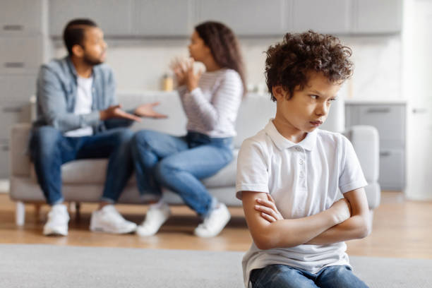 istock Young Boy Feeling Upset While Parents Argue in the Background 2152962627