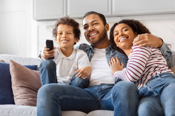 istock A Family Sitting on a Couch Holding a Remote Control 2152962659
