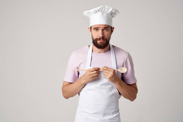 istock chef in the kitchen with a spoon in hand emotion cooking isolated background 2152962997