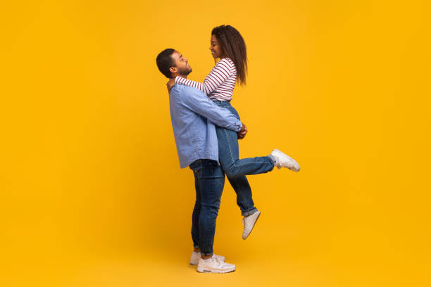 istock Side view of romantic young black man holding and hugging his girlfriend 2152963693