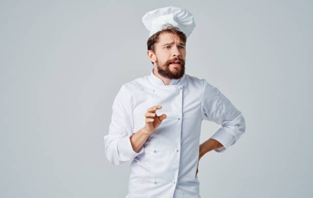 istock Professional cook in uniform headdress gesturing with hands Copy Space 2152963790