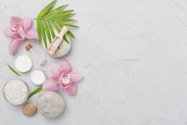istock Composition with orchids and massage stones on concrete background, top view 2152965261