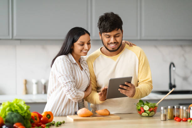 istock Beautiful loving spouses making food, watching video content on tablet 2152965932