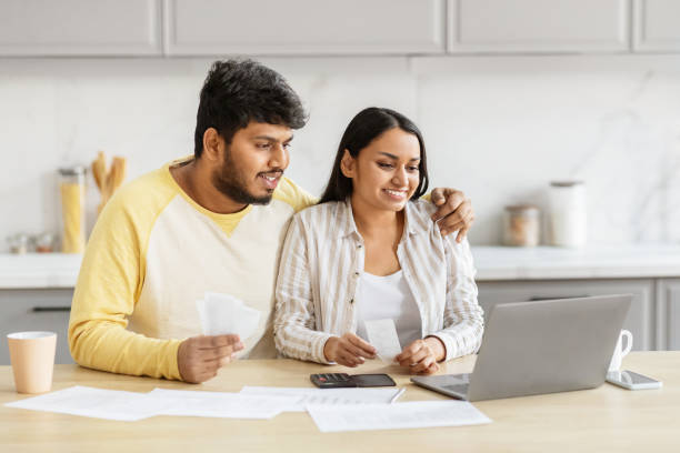 istock Indian couple reviewing finances with a laptop 2152965946