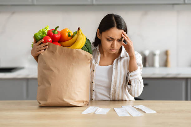 istock Frustrated indian lady checking bills after grocery shopping 2152965993