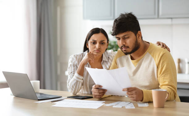 istock Upset young indian couple paying bills online 2152966040