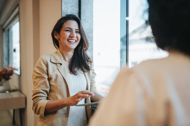 istock Smiling businesswomen interacting 2152966632