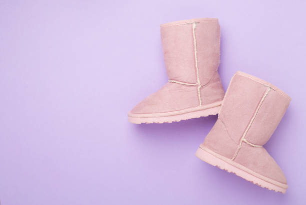 Beautiful boots on color background,top view