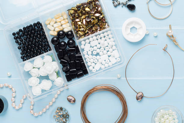 istock Tools and beads for making handmade jewelry on wooden background, top view 2152967173