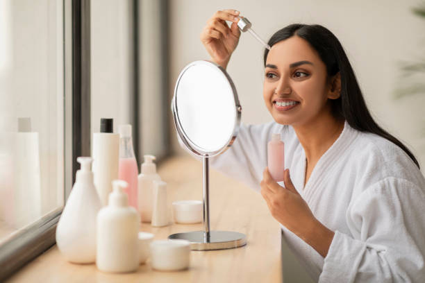 istock Attractive millennial indian woman applying serum on face 2152967270