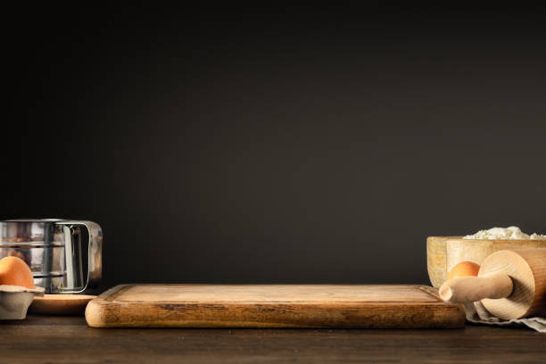 Bakery background, Wooden empty table with board and ingredients for preparing dough on dark background. Place for your product