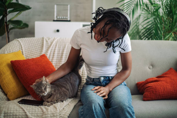 istock Woman enjoying time with a cat on the sofa 2152968933
