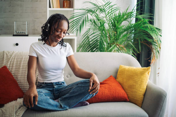 istock Casual woman sitting on couch with cushions 2152969172