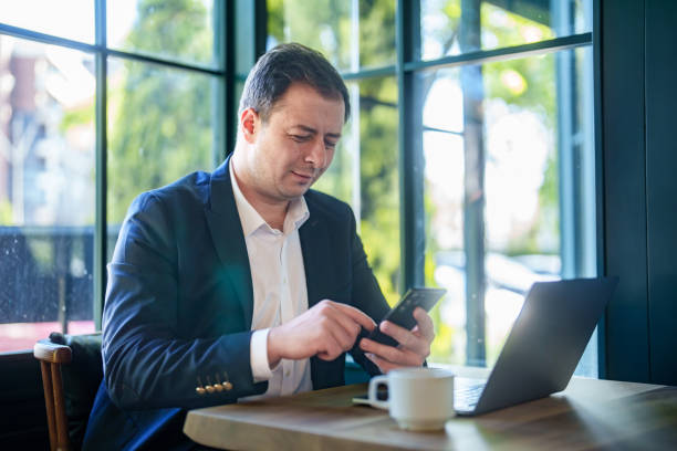 istock Businessman working with laptop and mobile phone. in cafe. 2152971654