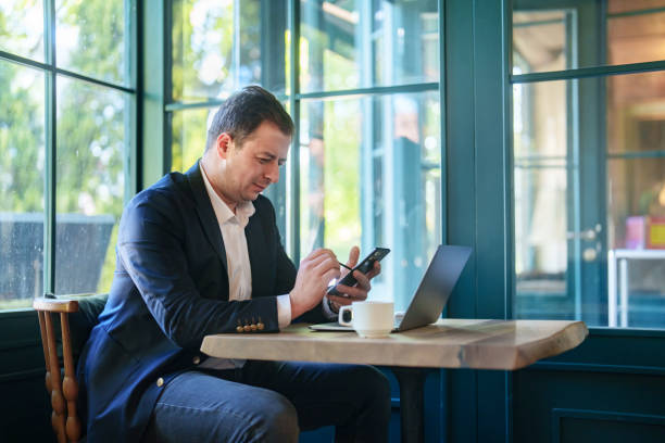 istock Businessman working with laptop and mobile phone. in cafe. 2152971714