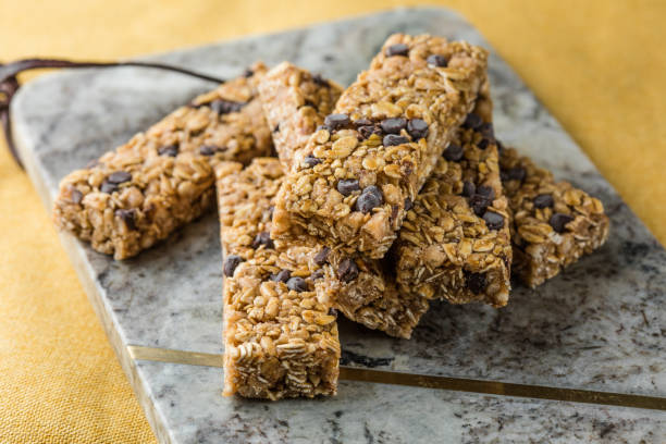 istock Various granola bars on table background. Cereal granola bars. Superfood breakfast bars with oats, nuts and berries, close up. 2152971842