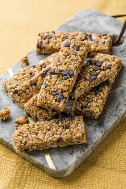 istock Various granola bars on table background. Cereal granola bars. Superfood breakfast bars with oats, nuts and berries, close up. 2152971844