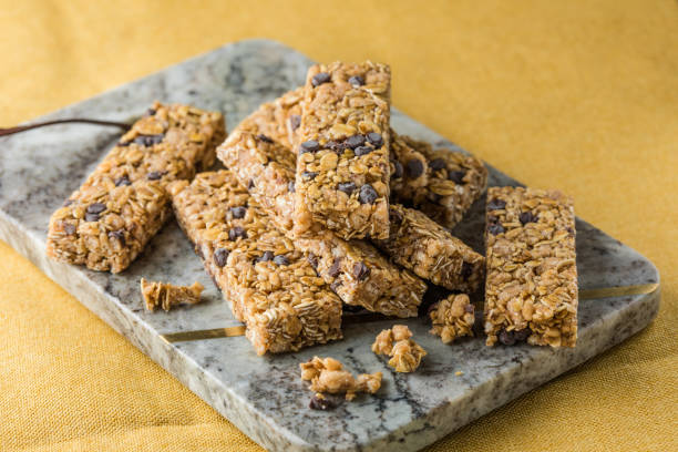 istock Various granola bars on table background. Cereal granola bars. Superfood breakfast bars with oats, nuts and berries, close up. 2152971846