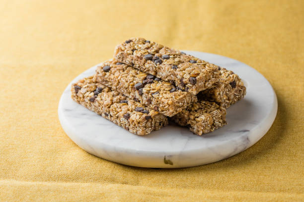 istock Various granola bars on table background. Cereal granola bars. Superfood breakfast bars with oats, nuts and berries, close up. 2152971850