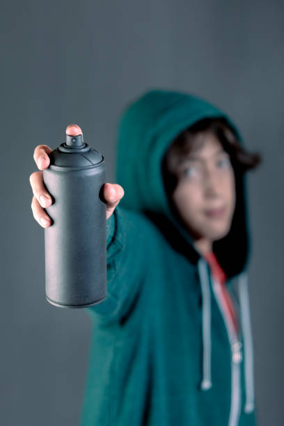 London, United Kingdom - January 26, 2013: Young Graffiti Artist Spraying Walls With Paint in Capital City.