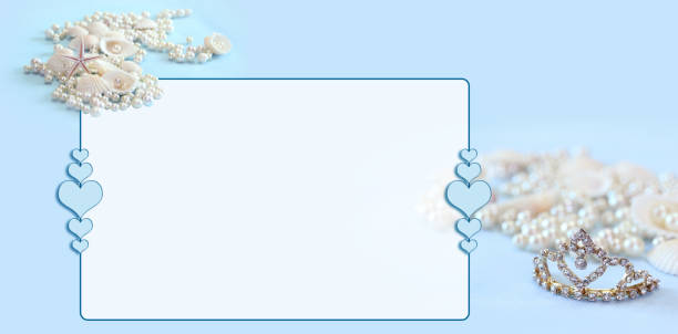 shell and pearls and tiara on blue background. frame of many hearts