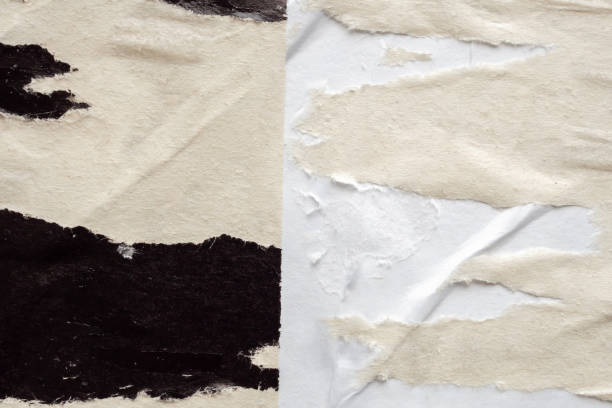 istock Old grunge ripped torn black paper poster surface texture background 2152976796
