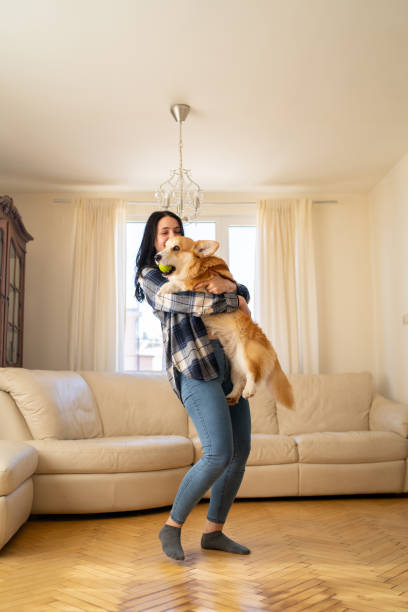 istock A woman cuddling her Corgi dog 2152976869