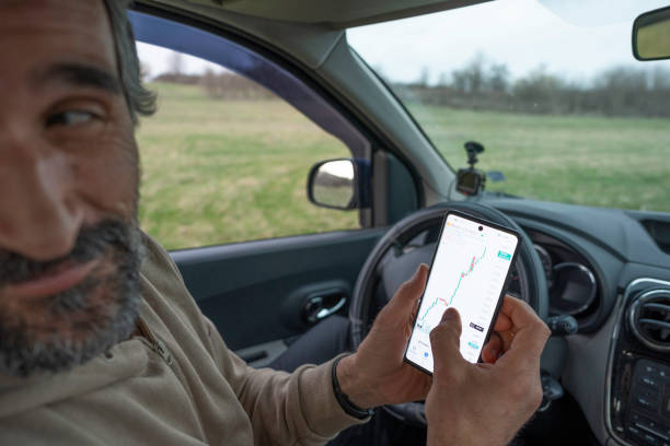 istock Investing Everywhere. Trader in His Car Trading Cryptocurrency. 2152977118