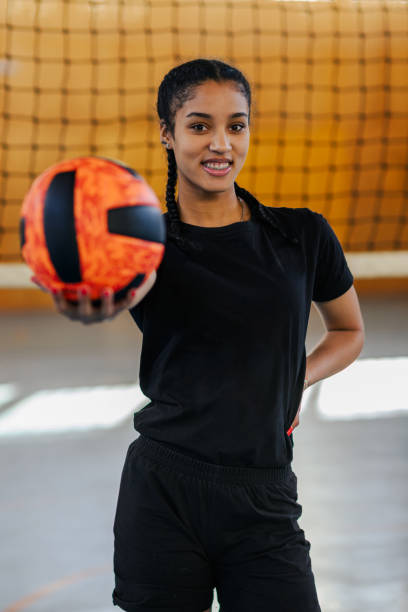 istock Multiracial girl posing while holding volleyball ball in her hand 2152977309