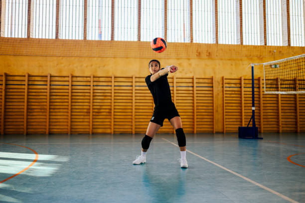 istock Young female volleyball player bumping a ball and practicing volleyball 2152977318