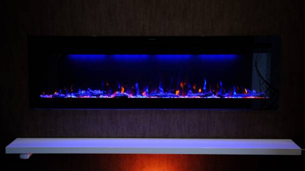 istock view on electric fireplace with artificial sparkling flame, decor for the interior, orange and blue flame 2152977473