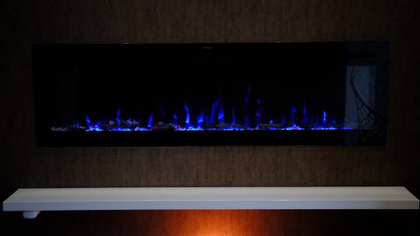 istock view on electric fireplace with artificial sparkling flame, decor for the interior, blue flame on crystals 2152977506