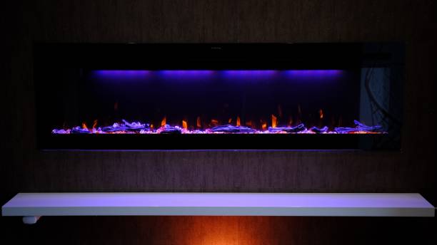 istock view on electric fireplace with artificial sparkling flame, decor for the interior, orange flame on crystals 2152977533