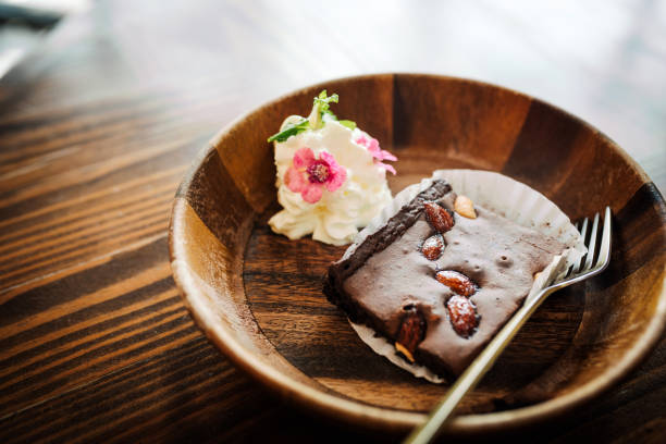 Piece of chocolate brownie with almonds. Tasty breakfast