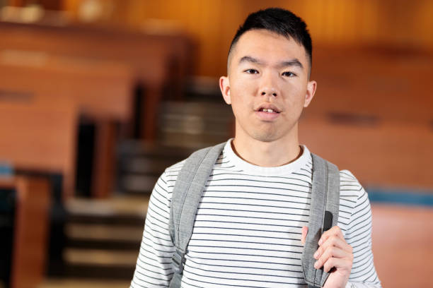 istock A smart college student standing in a lecture hall classroom 2152978711