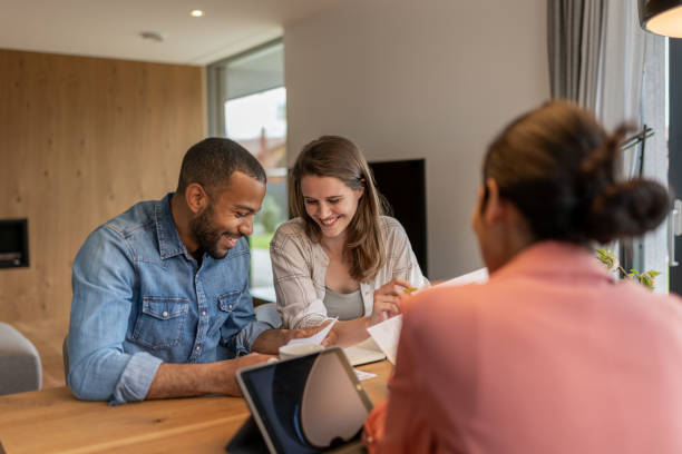 istock A financial advisor advises a multiracial couple at home 2152979164