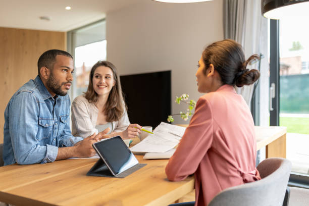 istock A financial advisor advises a multiracial couple at home 2152979171