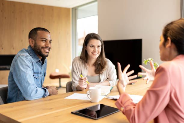 istock A financial advisor advises a multiracial couple at home 2152979172