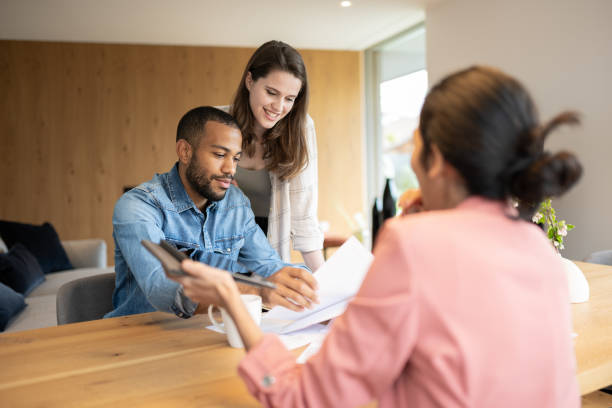 istock A financial advisor advises a multiracial couple at home 2152979174