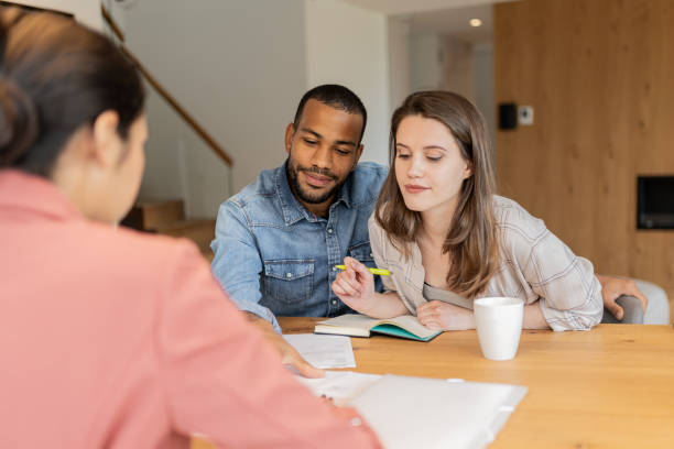 istock A financial advisor advises a multiracial couple at home 2152979175