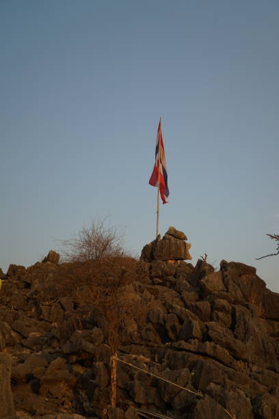 istock A flag is on top of a rocky hill 2152986136