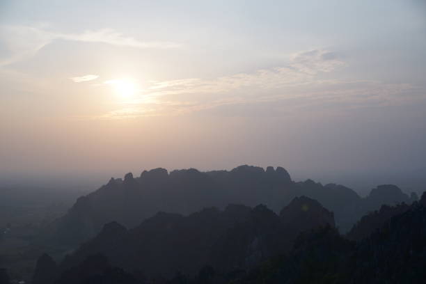 istock The sky is a beautiful shade of blue with a sun setting in the background 2152986155